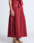 Close-up of the artisanal contrast stitching on the wine cotton Milena Skirt.