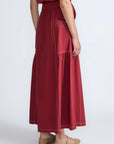 Detail of the adjustable waistband with metal toppers on the Milena Skirt.
