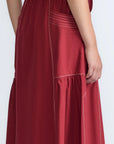 Close-up of the artisanal contrast stitching on the wine cotton Milena Skirt.
