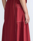 Close-up of the artisanal contrast stitching on the wine cotton Milena Skirt.