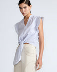 Oriana Blouse in Light Blue Stripes – Cotton blouse with V-neck, Neru collar, ruffled sleeves, appliqué trim, and tie-front hem.