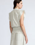 Oriana Blouse in Silver – Cotton blouse with V-neckline, Neru collar, ruffled sleeve details, tie hem, and appliqué embellishment.