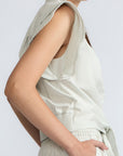 Oriana Blouse in Silver – Cotton blouse with V-neckline, Neru collar, ruffled sleeve details, tie hem, and appliqué embellishment.