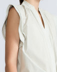 Oriana Blouse in Silver – Cotton blouse with V-neckline, Neru collar, ruffled sleeve details, tie hem, and appliqué embellishment.