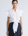 Oriana Blouse in White – Elegant cotton blouse with V-neck, Neru collar, ruffle sleeves, tie waist, and hand-appliqué detailing.