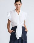Oriana Blouse in White – Elegant cotton blouse with V-neck, Neru collar, ruffle sleeves, tie waist, and hand-appliqué detailing.