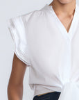 Oriana Blouse in White – Elegant cotton blouse with V-neck, Neru collar, ruffle sleeves, tie waist, and hand-appliqué detailing.