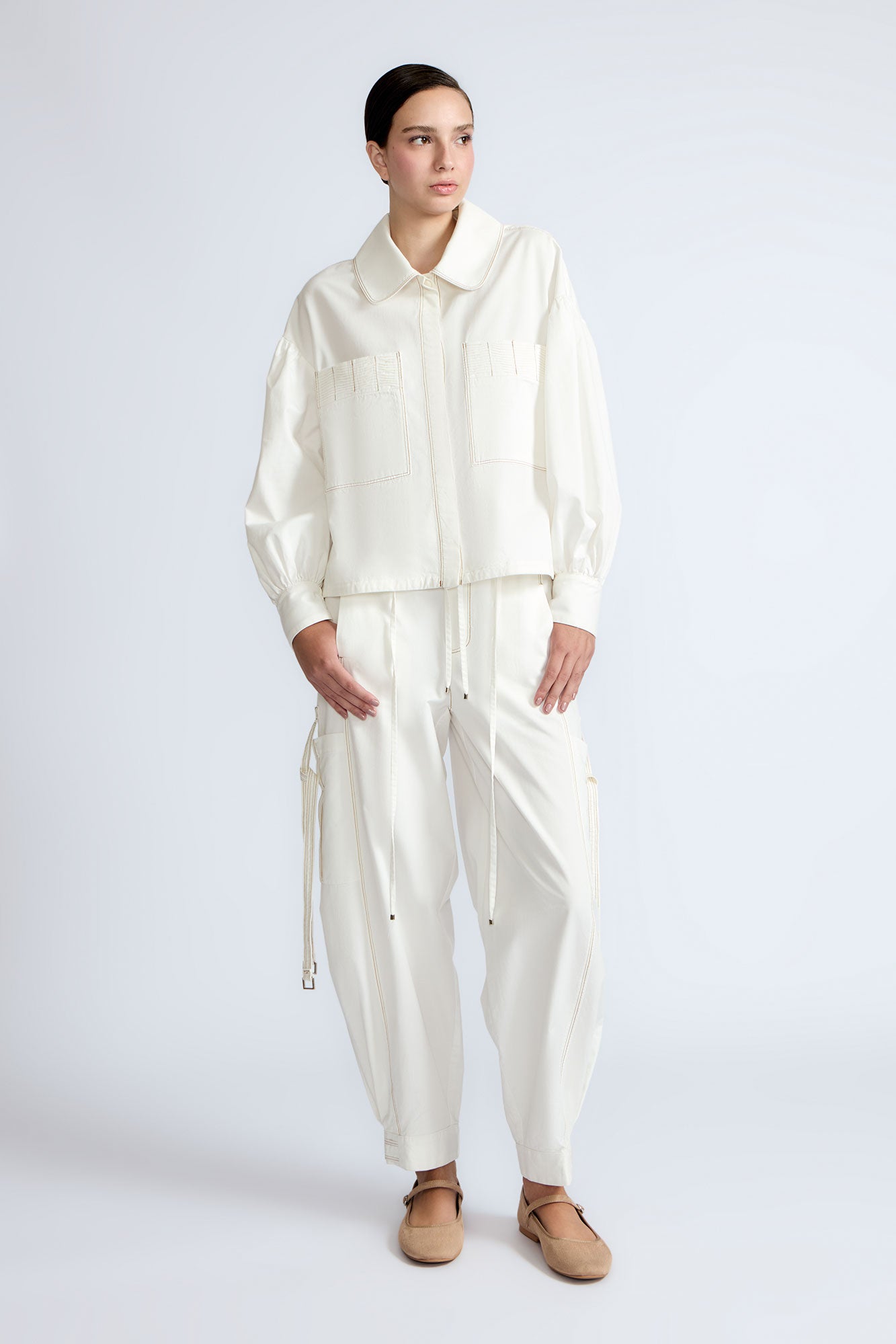 Paloma Pant in Off White – Relaxed cotton pants with patch pockets, contrast stitching, and side ties for a chic silhouette.