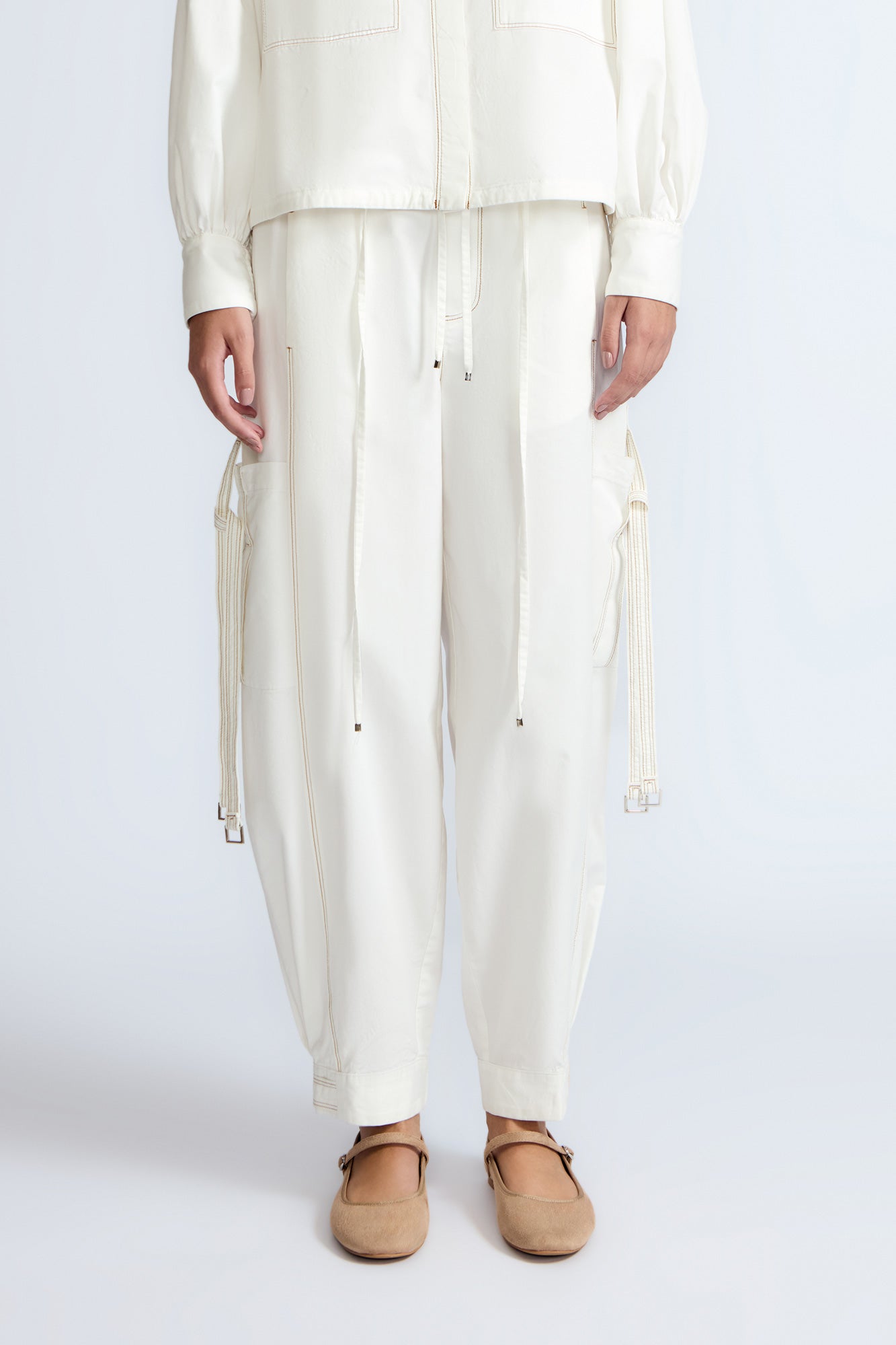 Paloma Pant in Off White – Relaxed cotton pants with patch pockets, contrast stitching, and side ties for a chic silhouette.