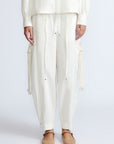Paloma Pant in Off White – Relaxed cotton pants with patch pockets, contrast stitching, and side ties for a chic silhouette.