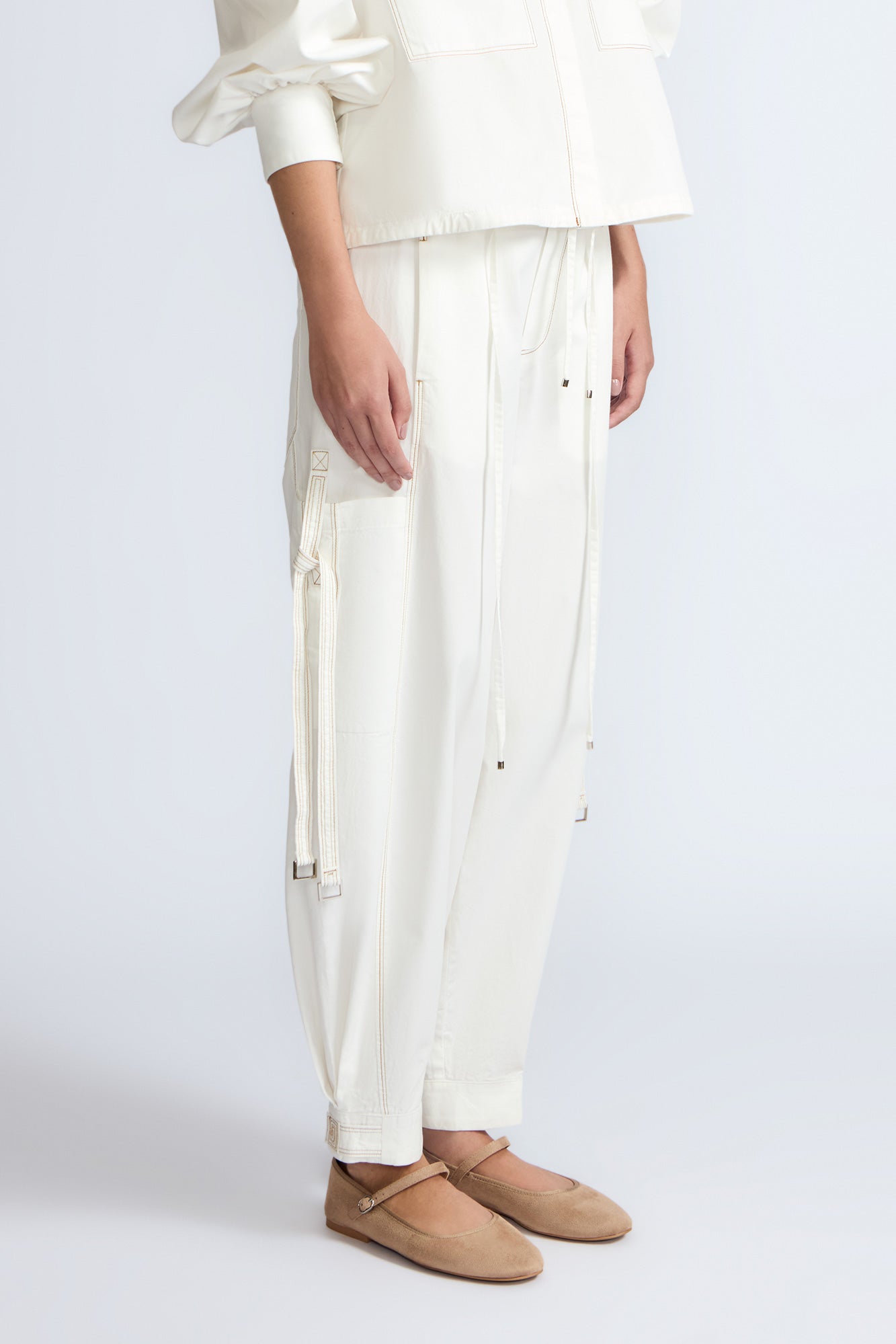 Paloma Pant in Off White – Relaxed cotton pants with patch pockets, contrast stitching, and side ties for a chic silhouette.