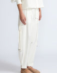 Paloma Pant in Off White – Relaxed cotton pants with patch pockets, contrast stitching, and side ties for a chic silhouette.