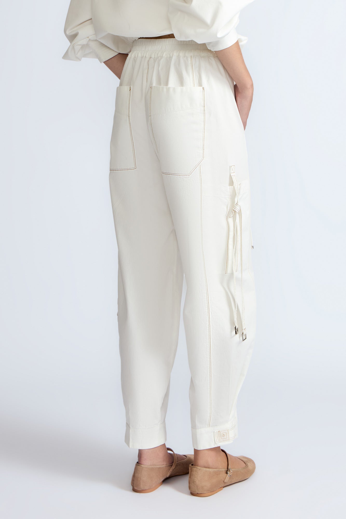 Paloma Pant in Off White – Relaxed cotton pants with patch pockets, contrast stitching, and side ties for a chic silhouette.