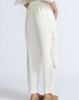 Paloma Pant in Off White – Relaxed cotton pants with patch pockets, contrast stitching, and side ties for a chic silhouette.