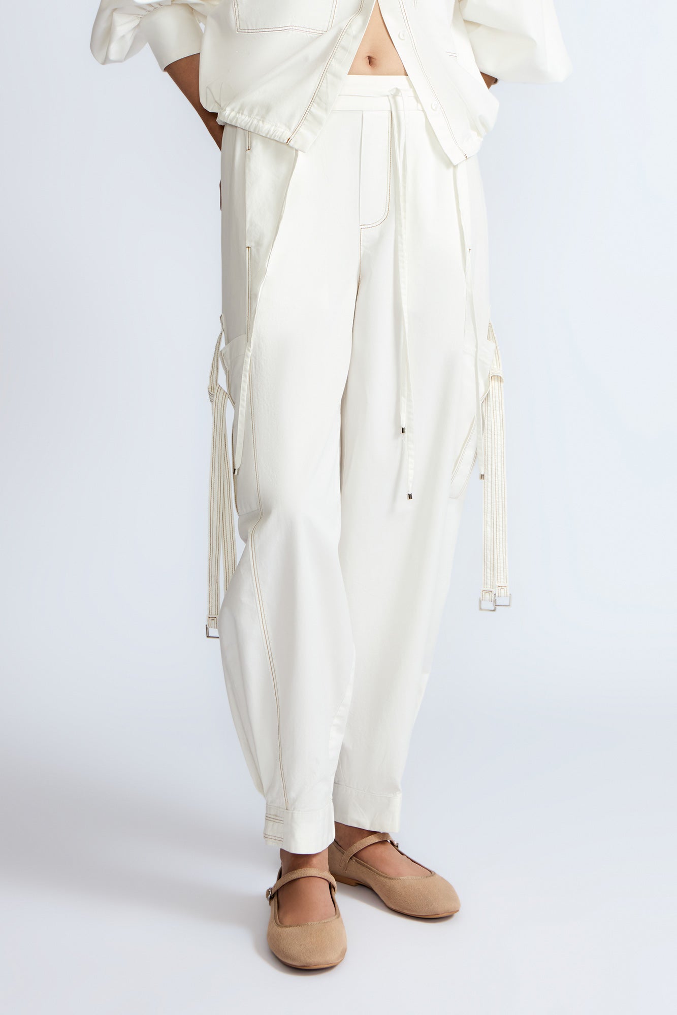 Paloma Pant in Off White – Relaxed cotton pants with patch pockets, contrast stitching, and side ties for a chic silhouette.