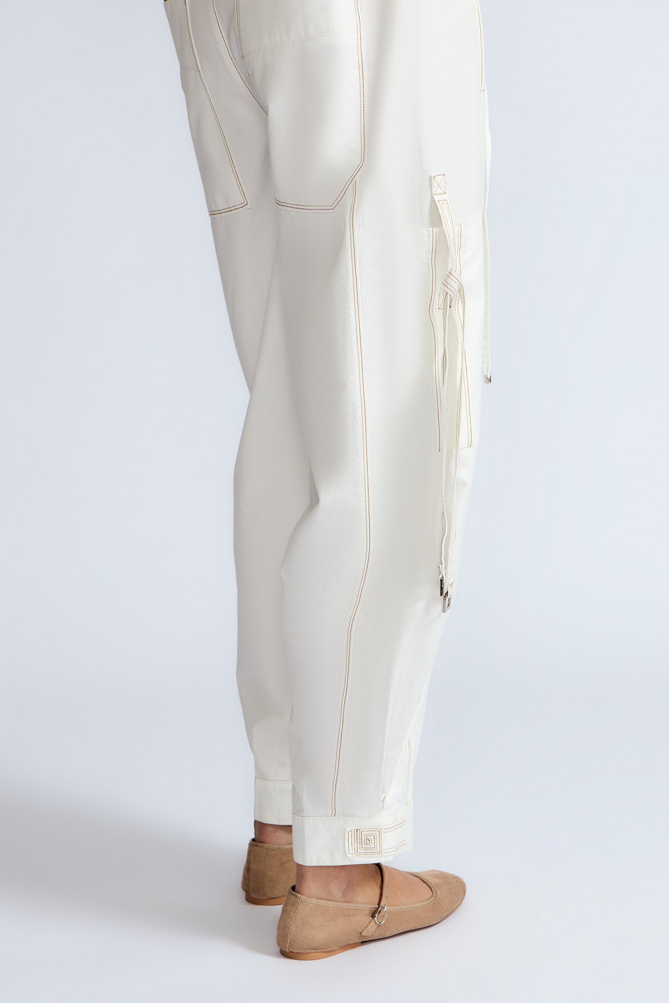 Paloma Pant in Off White – Relaxed cotton pants with patch pockets, contrast stitching, and side ties for a chic silhouette.