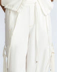 Paloma Pant in Off White – Relaxed cotton pants with patch pockets, contrast stitching, and side ties for a chic silhouette.