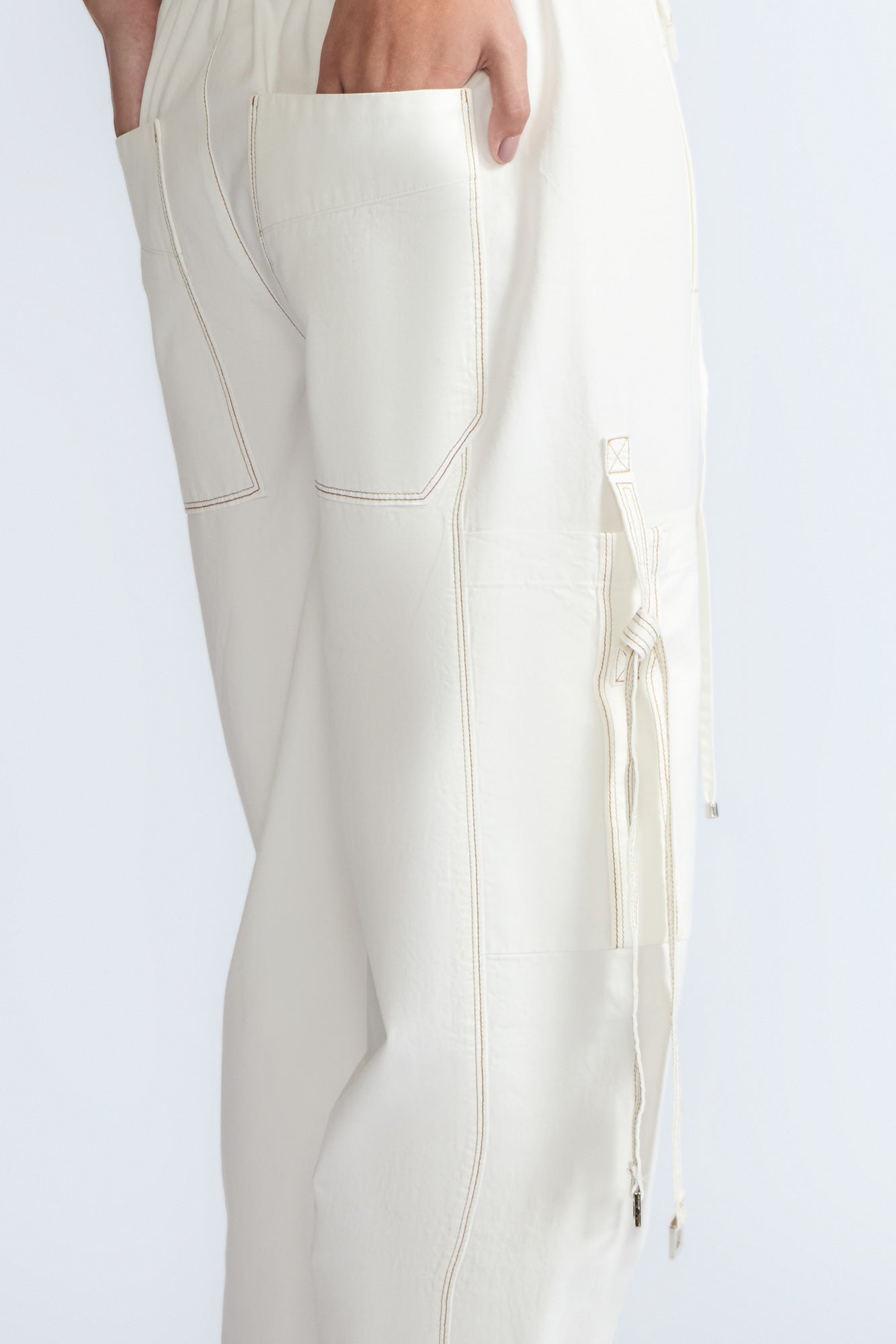 Paloma Pant in Off White – Relaxed cotton pants with patch pockets, contrast stitching, and side ties for a chic silhouette.