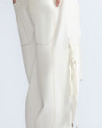 Paloma Pant in Off White – Relaxed cotton pants with patch pockets, contrast stitching, and side ties for a chic silhouette.
