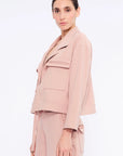 Side profile of the Rose Parker Jacket, highlighting its modern waist-length silhouette.