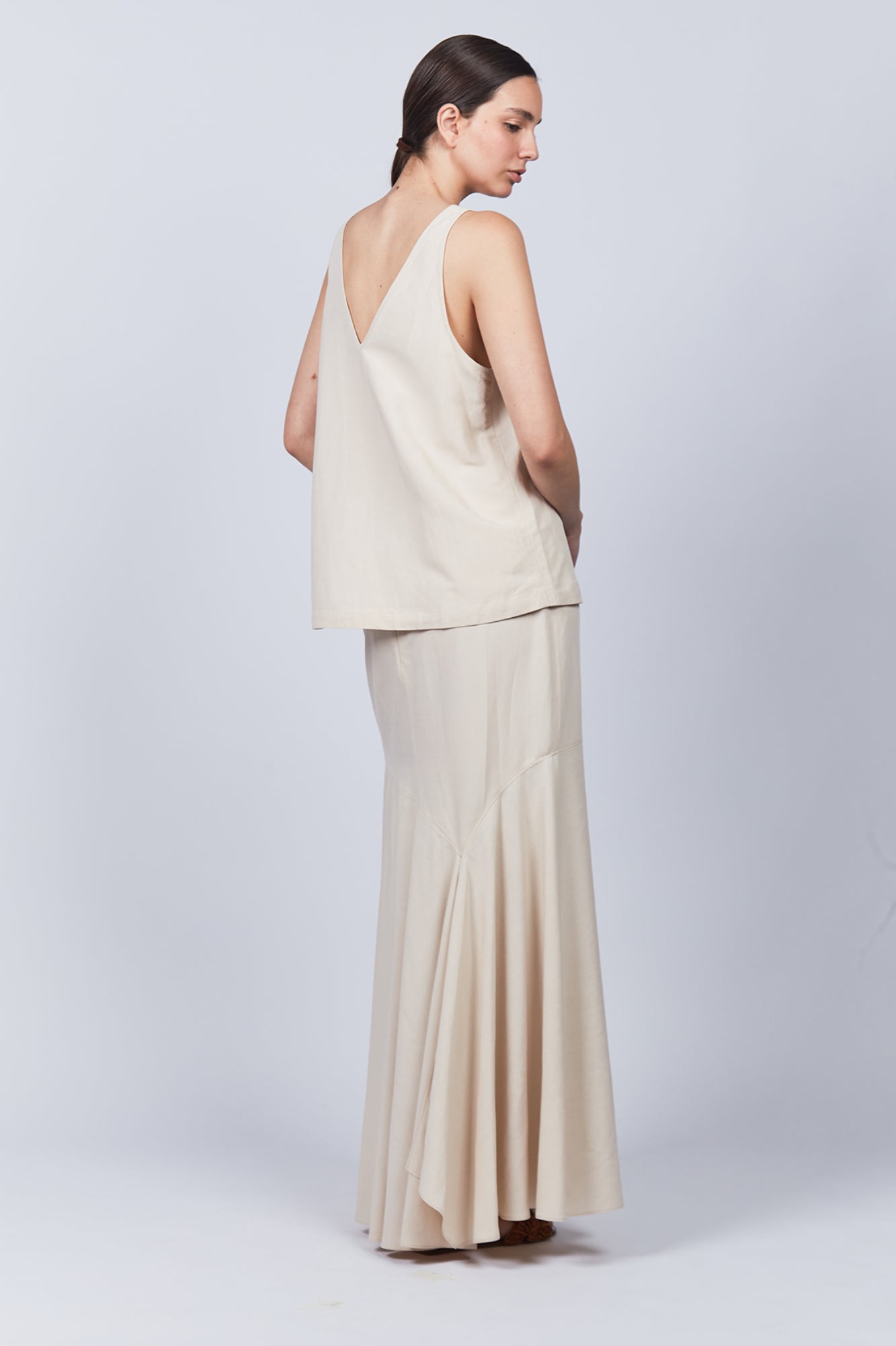 Penny Skirt in Ecru featuring a high-waisted flowing silhouette, perfect for versatile and elegant styling.