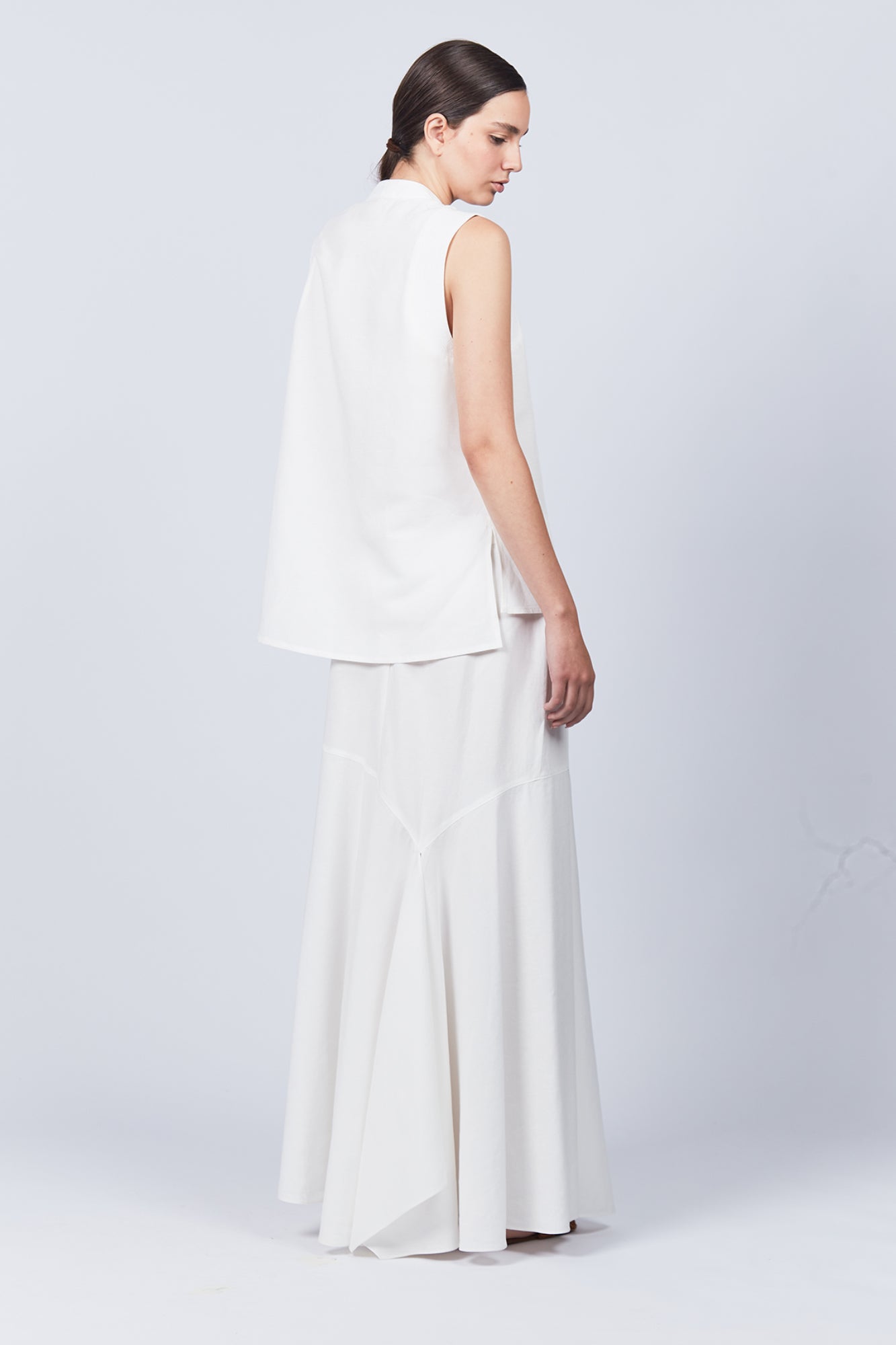 Penny Skirt in Off White with a high-waisted flowing silhouette, offering timeless elegance for any wardrobe.