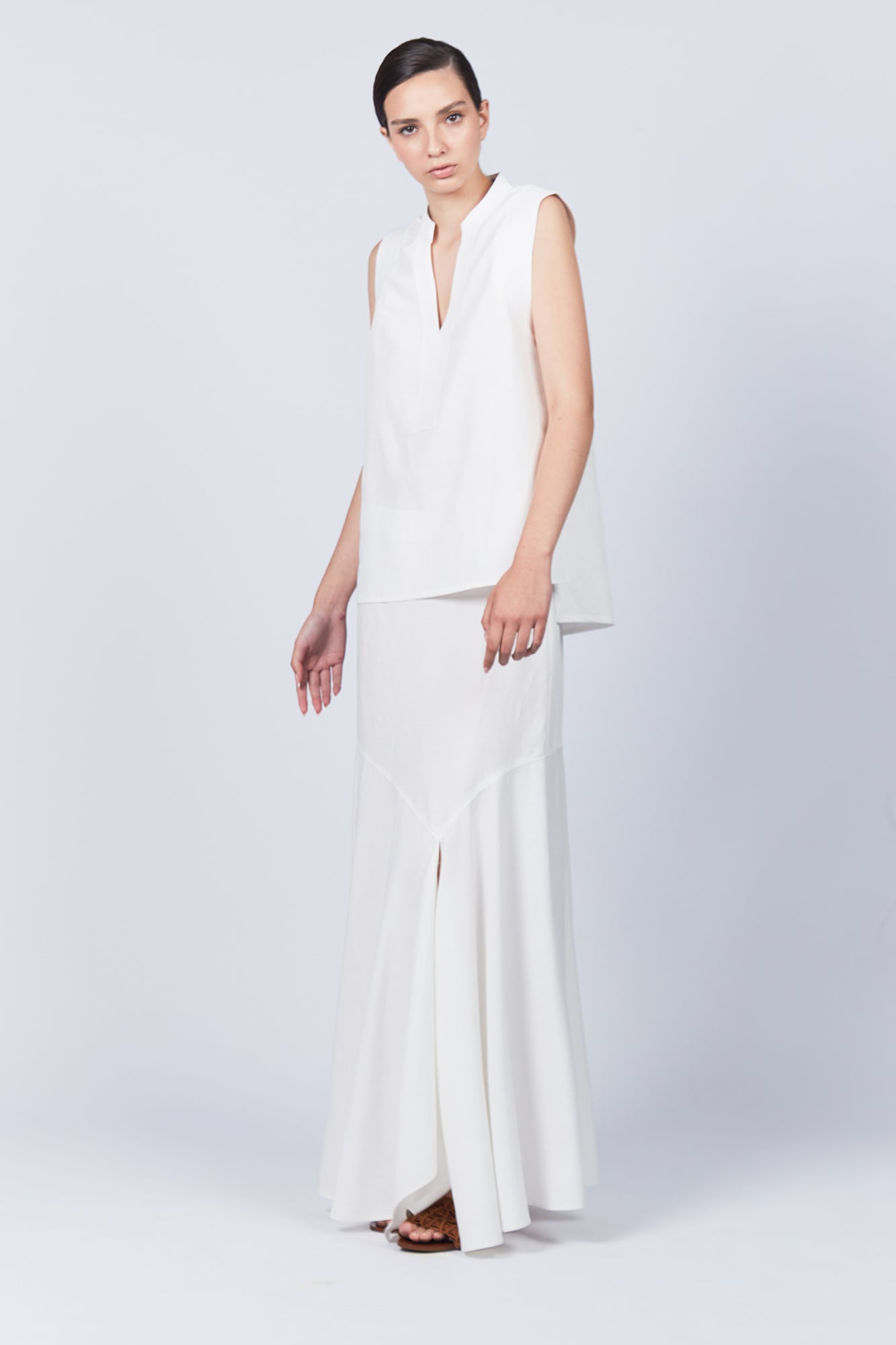 Penny Skirt in Off White with a high-waisted flowing silhouette, offering timeless elegance for any wardrobe.