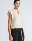 Pria Blouse in Prestine – Elegant sleeveless blouse in pima cotton with tonal V-neck, Greca trim, ruffle detail, and hem with pullers.
