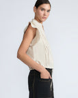 Pria Blouse in Prestine – Elegant sleeveless blouse in pima cotton with tonal V-neck, Greca trim, ruffle detail, and hem with pullers.