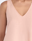 Close-up of the adjustable drawstring and polished metal stopper on the waist of the Rose Ryan Top.