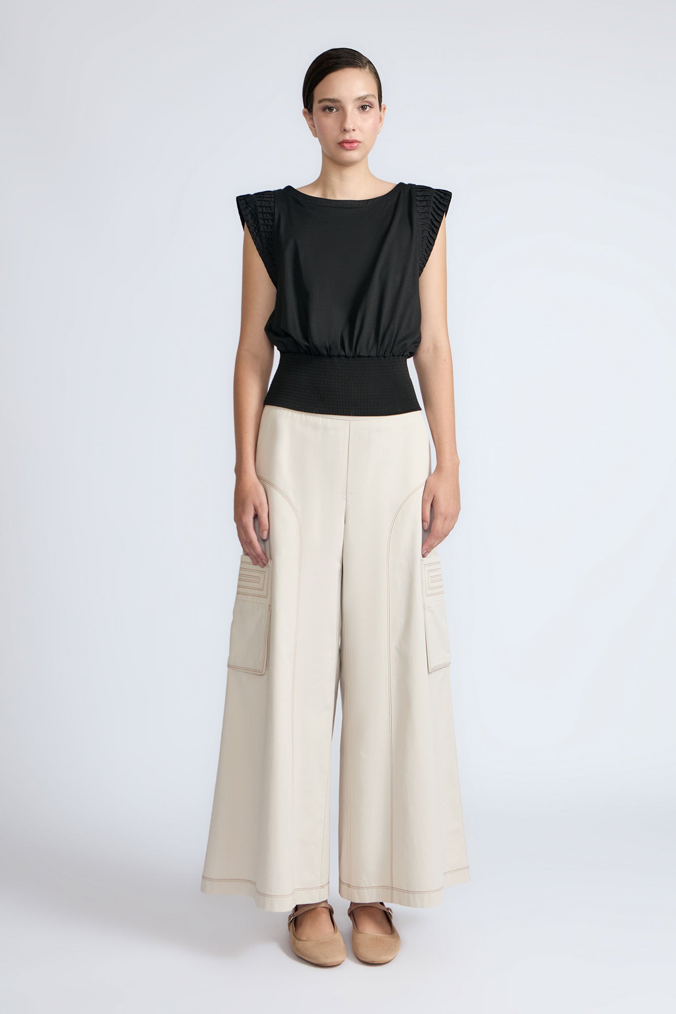 Selena Top in Black – Sleeveless cotton top with round neckline, semi-ruffled sleeves, and elasticized waistband.