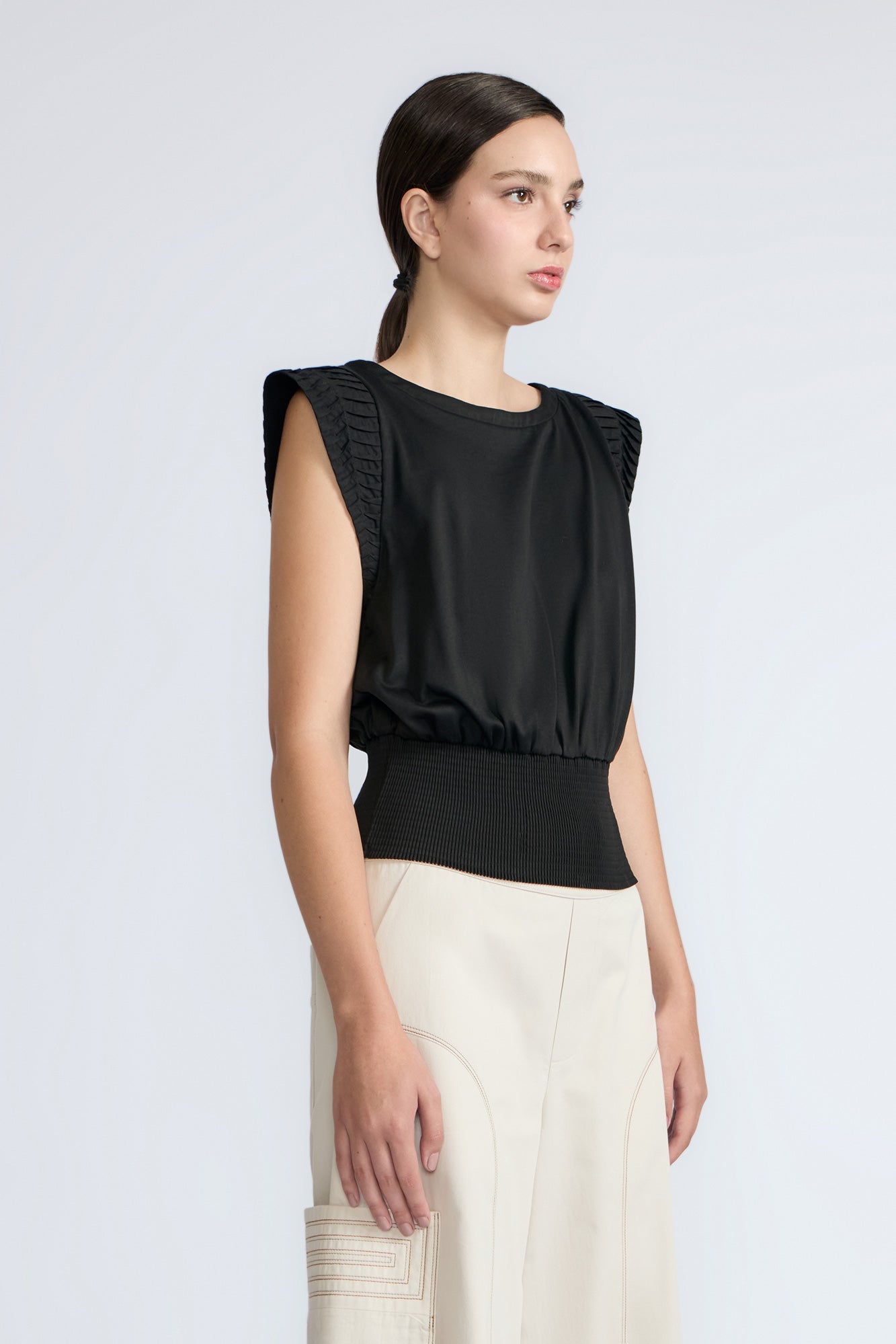 Selena Top in Black – Sleeveless cotton top with round neckline, semi-ruffled sleeves, and elasticized waistband.