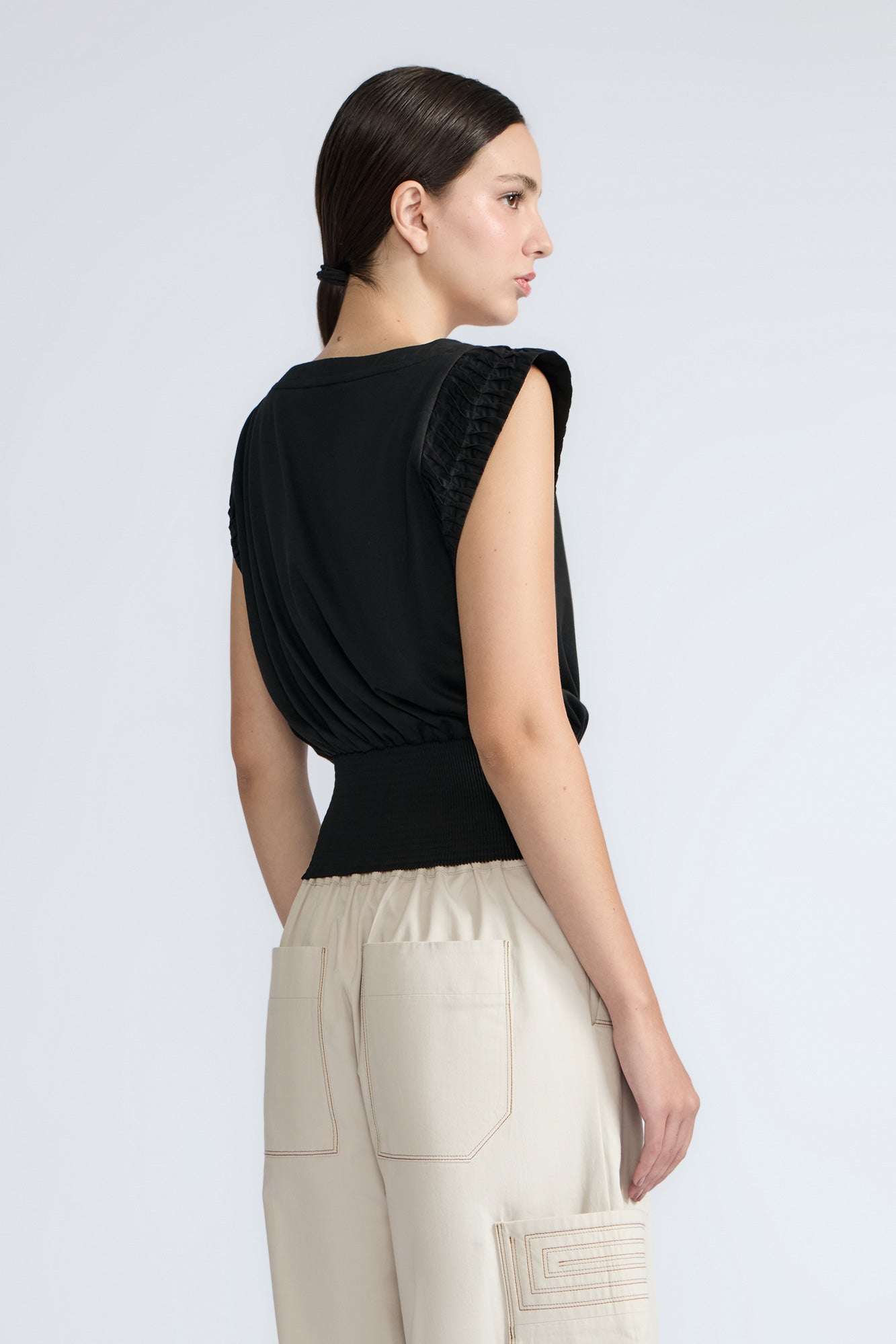 Selena Top in Black – Sleeveless cotton top with round neckline, semi-ruffled sleeves, and elasticized waistband.