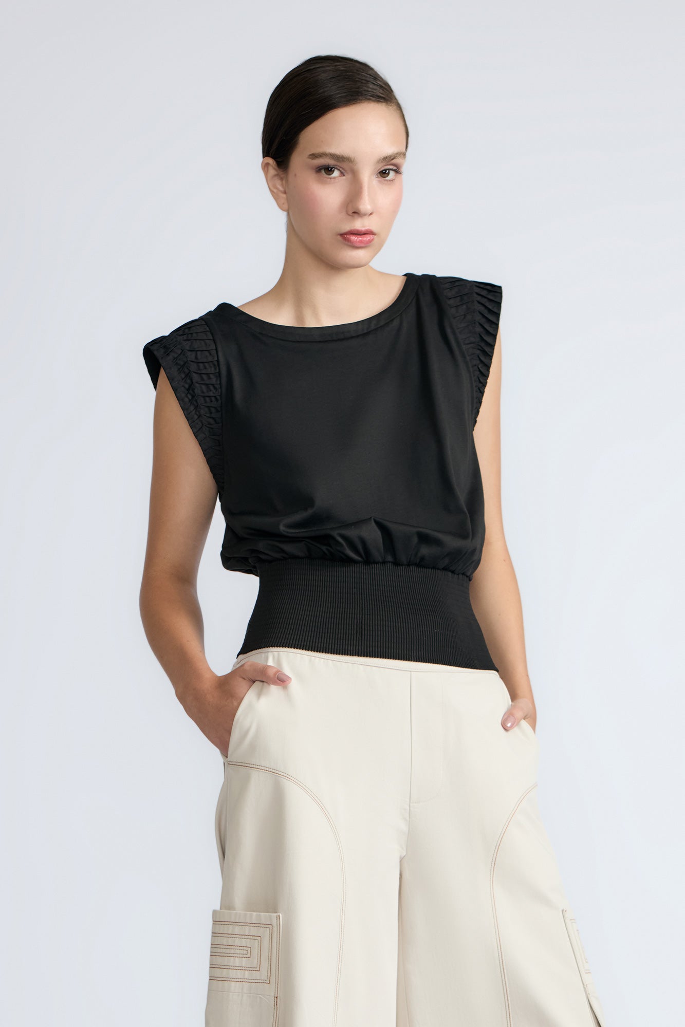 Selena Top in Black – Sleeveless cotton top with round neckline, semi-ruffled sleeves, and elasticized waistband.