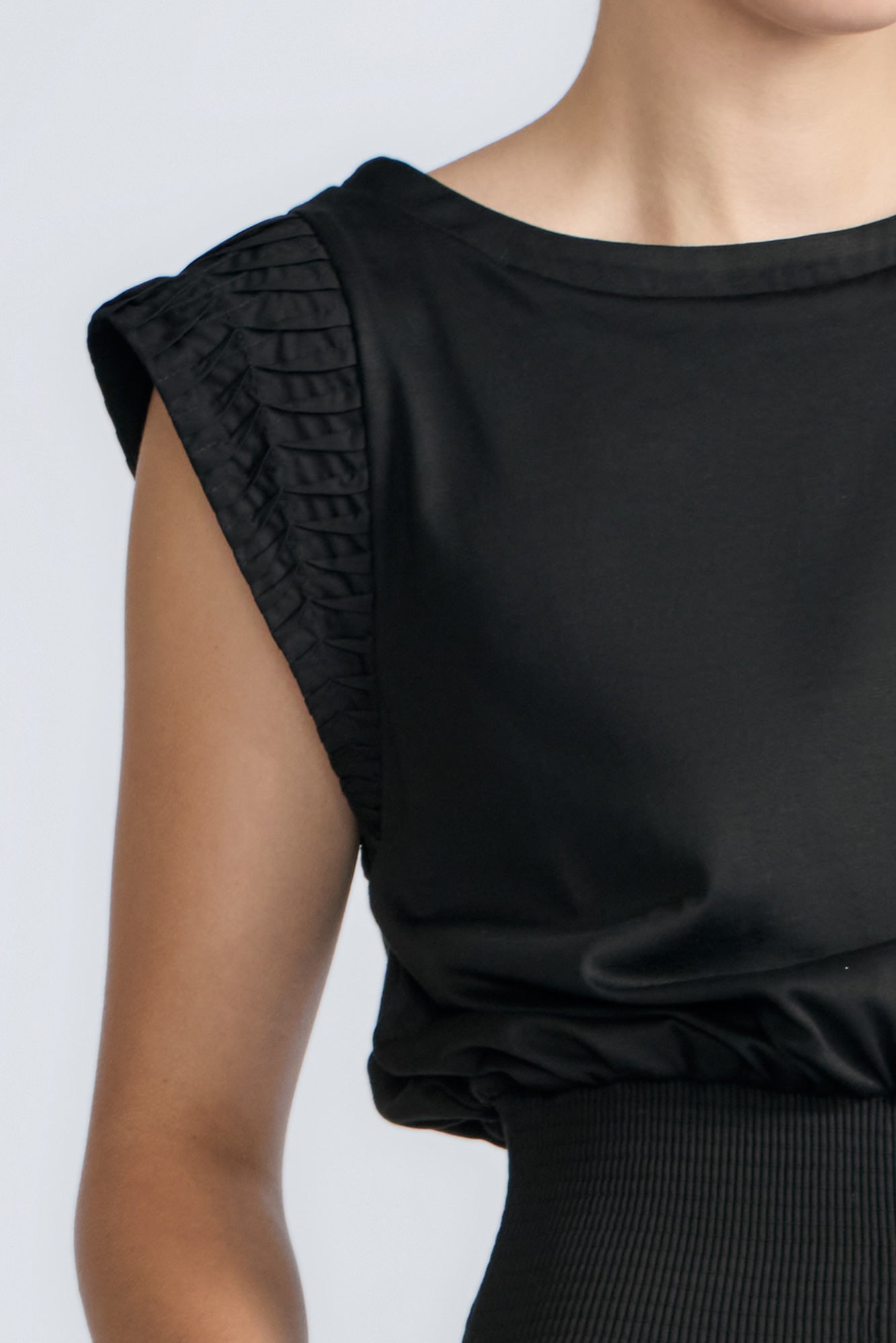 Selena Top in Black – Sleeveless cotton top with round neckline, semi-ruffled sleeves, and elasticized waistband.