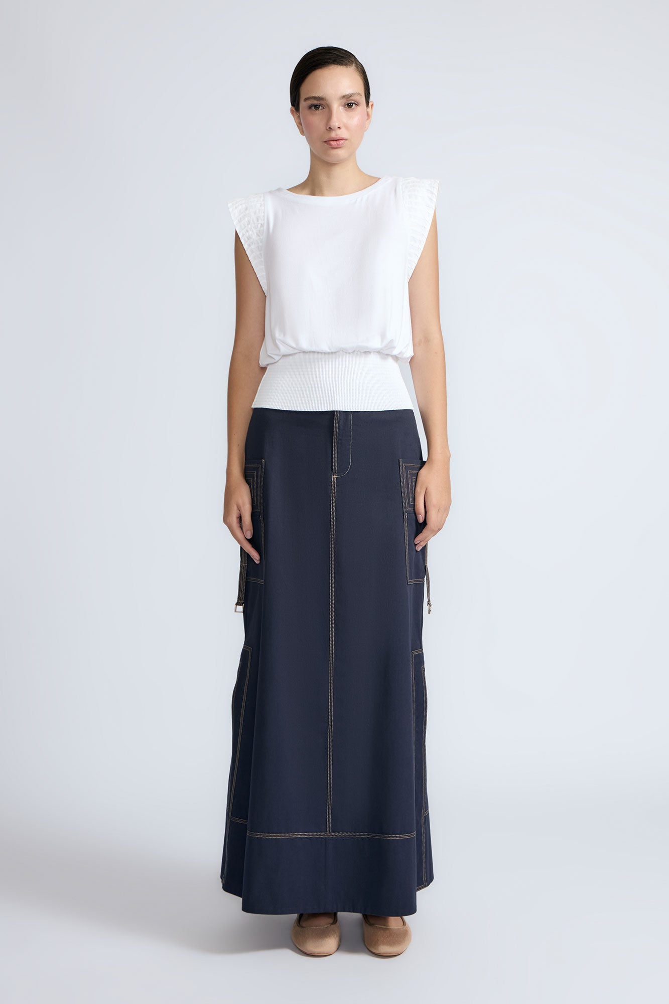 Selena Top in White – Soft cotton sleeveless top with round collar, ruffled arm details, and a gently cinched waist.