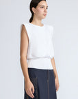 Selena Top in White – Soft cotton sleeveless top with round collar, ruffled arm details, and a gently cinched waist.