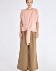 Front view of the Shelby Blouse in Rose, showcasing its classic round neckline and adjustable tie-hem.