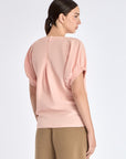 Back view of the Shelby Blouse, detailing the elegant button closure at the nape.