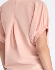 Back view of the Shelby Blouse, detailing the elegant button closure at the nape.