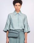 Sierra silk blouse in dark green with a sleek collar and balloon sleeves