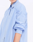 Close-up of the innovative drawstring that defines the shoulder of the Light Blue Star Blouse.