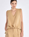 The Valencia Blouse in a rich Camel hue, showing its sleeveless design and premium linen blend.