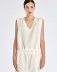The Valencia Blouse in Off White, featuring its clean sleeveless design and premium linen blend.