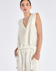 The Valencia Blouse in Off White, featuring its clean sleeveless design and premium linen blend.
