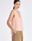Side profile of the Rose Valencia Blouse, highlighting the adjustable metal buckle detail at the hem.