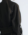 Zoe Jacket in Black – 100% cotton jacket with flap patch pockets, hidden buttons, long sleeves, and an adjustable drawstring hem.