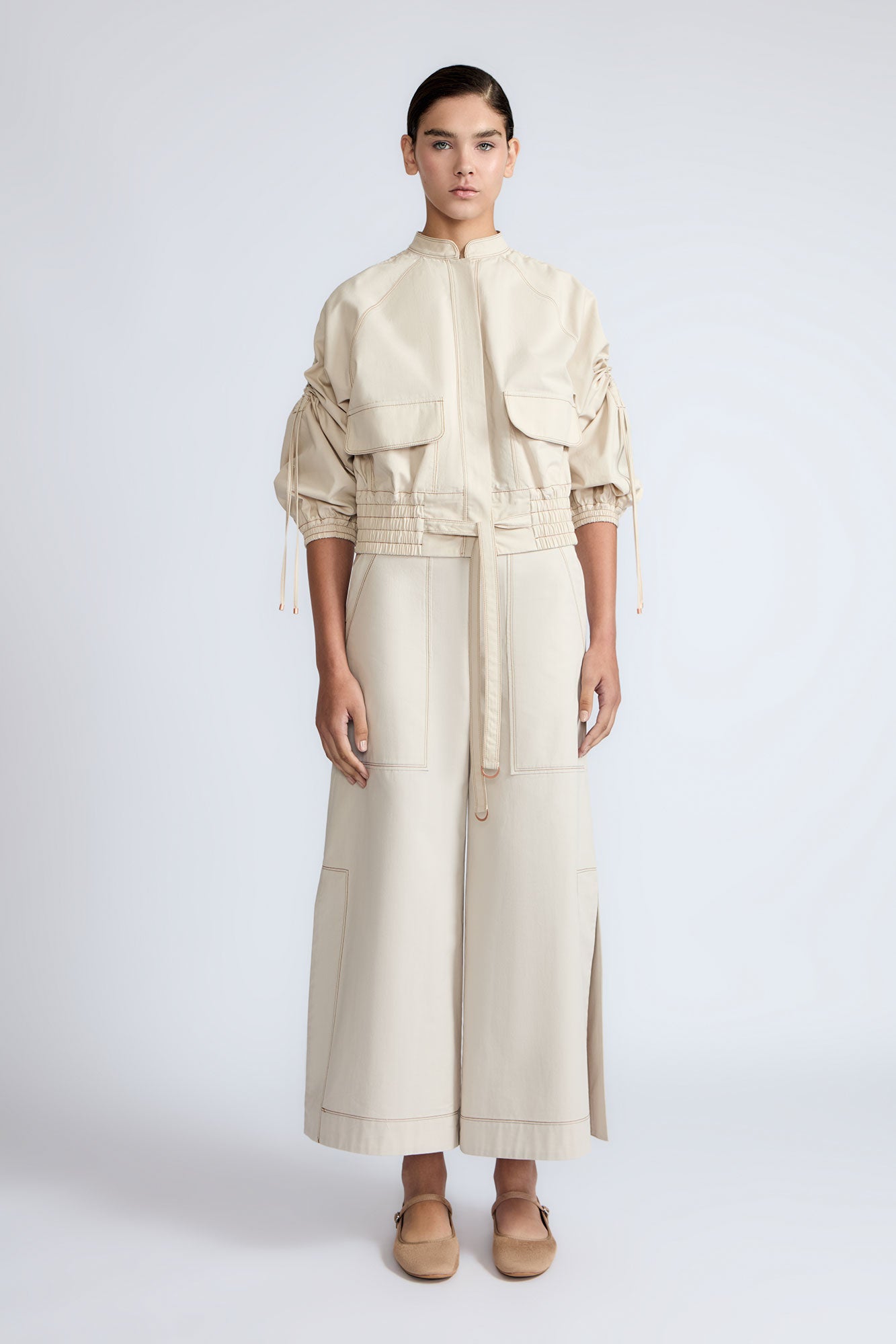 Zoe Jacket in Prestine – 100% cotton jacket with flap patch pockets, hidden buttons, long sleeves, and an adjustable drawstring hem.