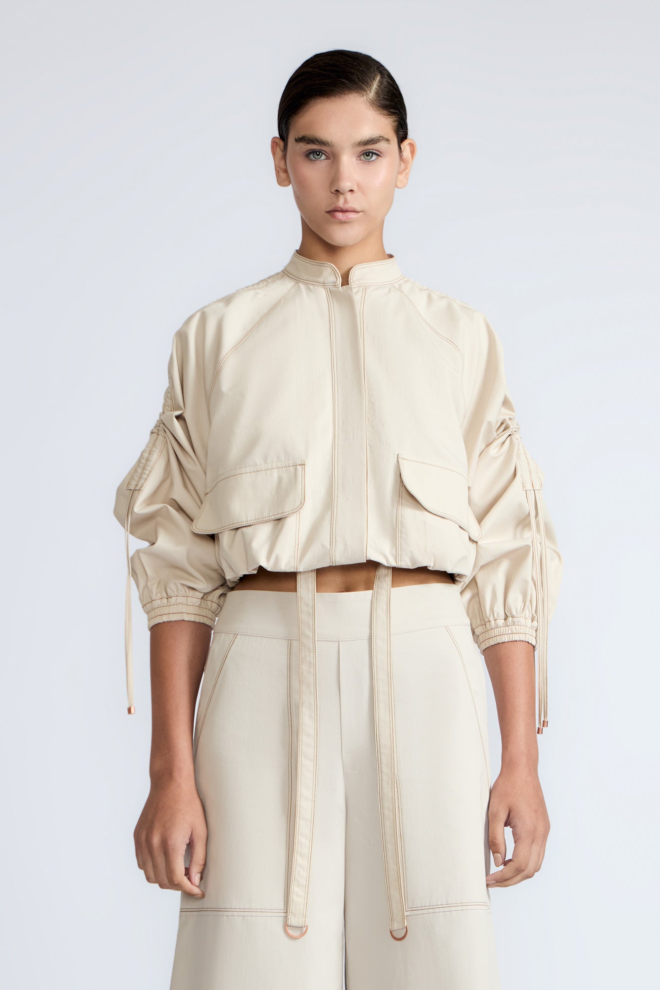 Zoe Jacket in Prestine – 100% cotton jacket with flap patch pockets, hidden buttons, long sleeves, and an adjustable drawstring hem.