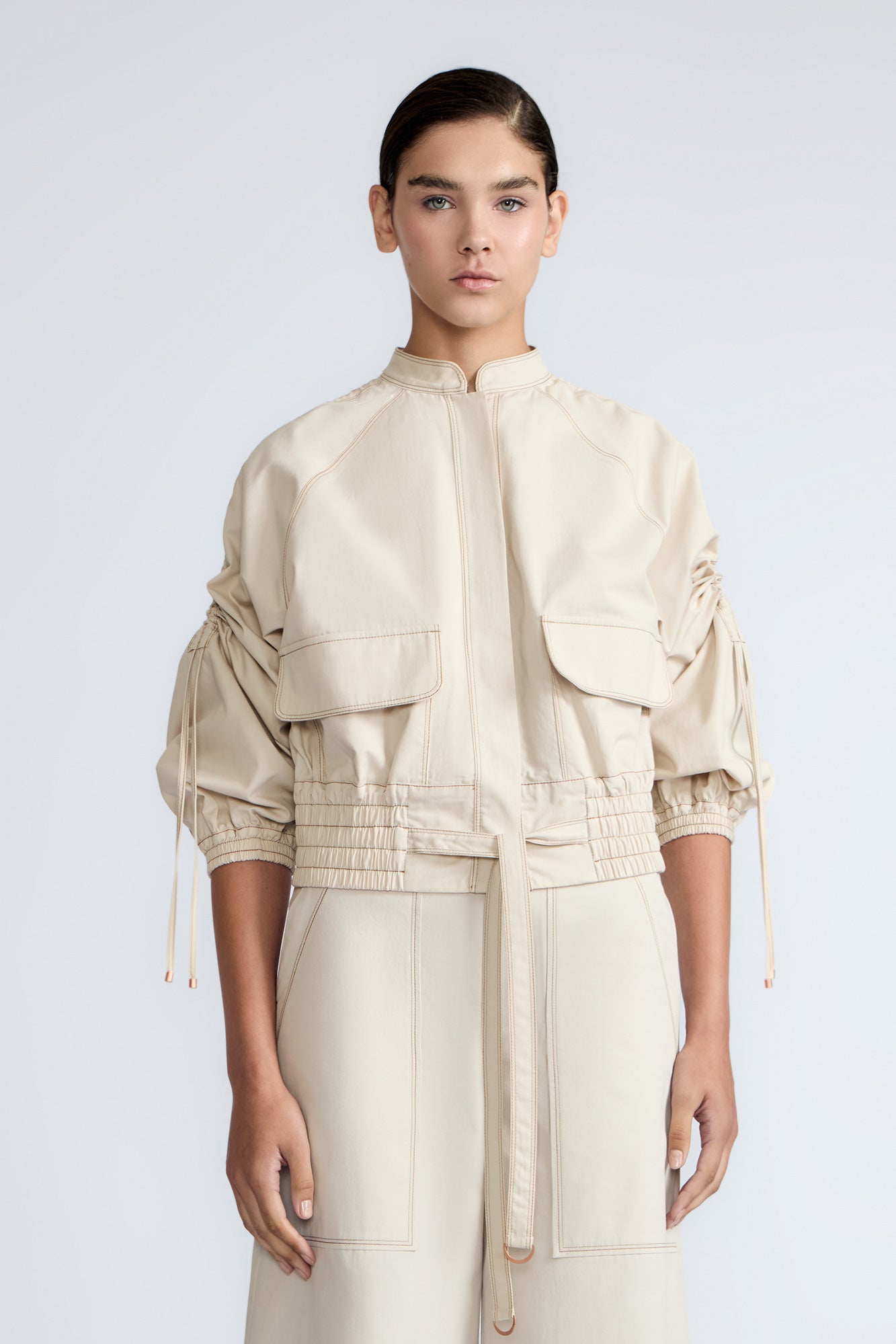 Zoe Jacket in Prestine – 100% cotton jacket with flap patch pockets, hidden buttons, long sleeves, and an adjustable drawstring hem.